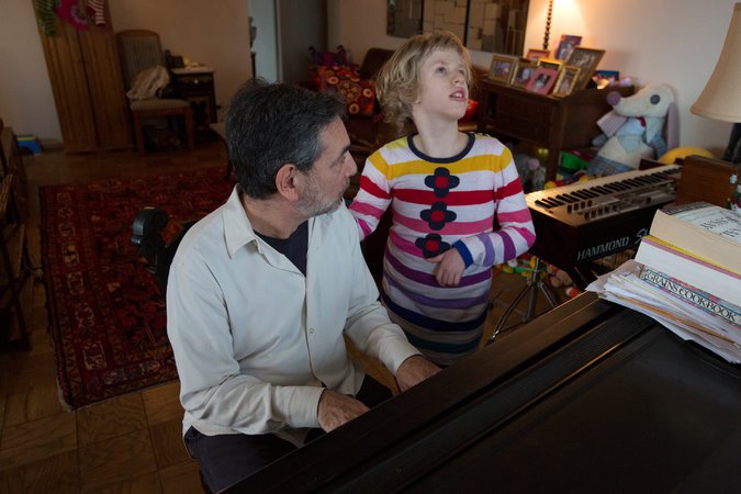 An adult and child in front of a grand piano practicing.