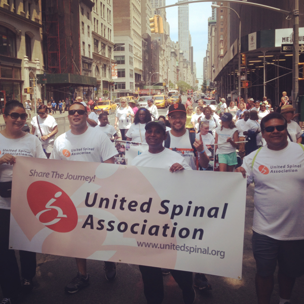 United Spinal Association group marching down the street