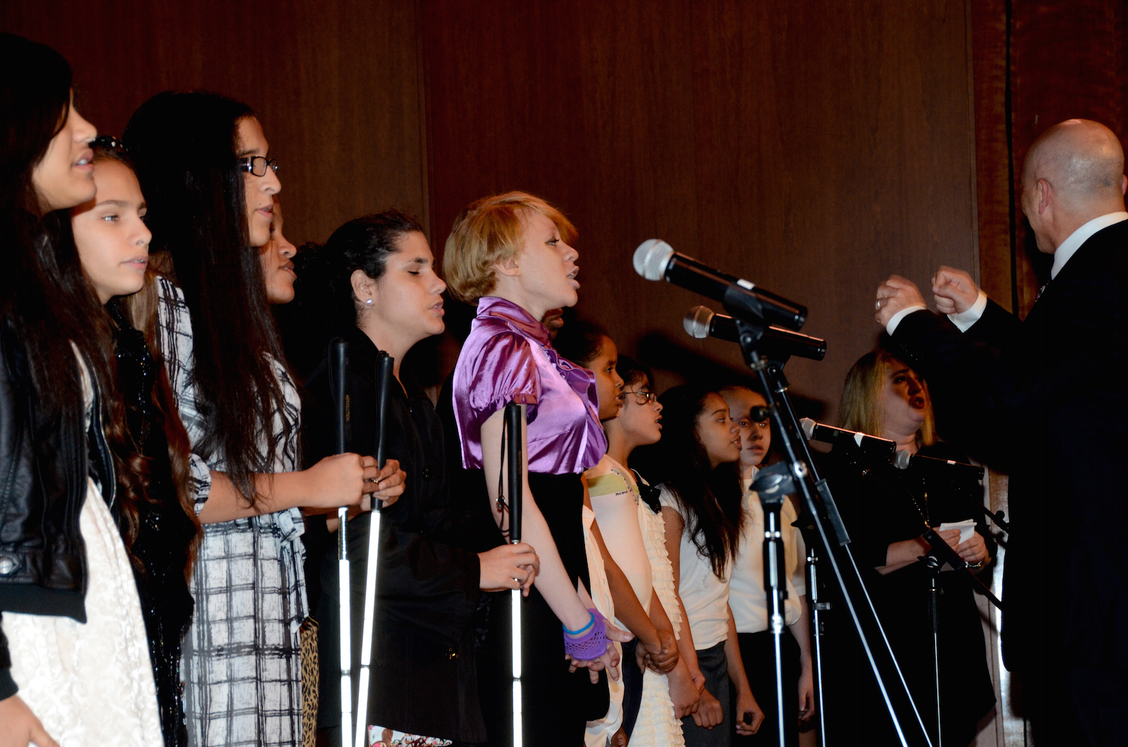 Members of the New York Institute for Special Education Choir, being conducted by Naum Shulman, in performance.