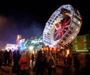 People walking besides the amusement rides