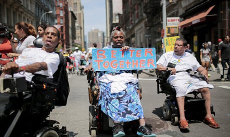 People on wheelchairs with different disabilities take part in the disability pride parade in New York