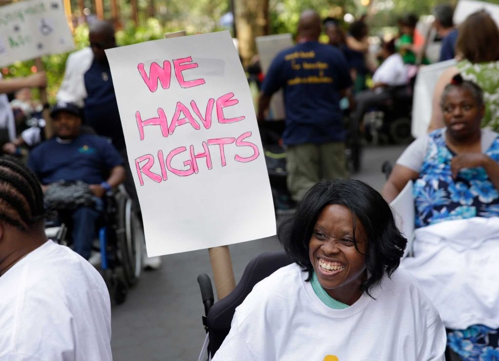 A group of people holding a sign saying "We have rights" A group of people holding a sign saying "We have rights"