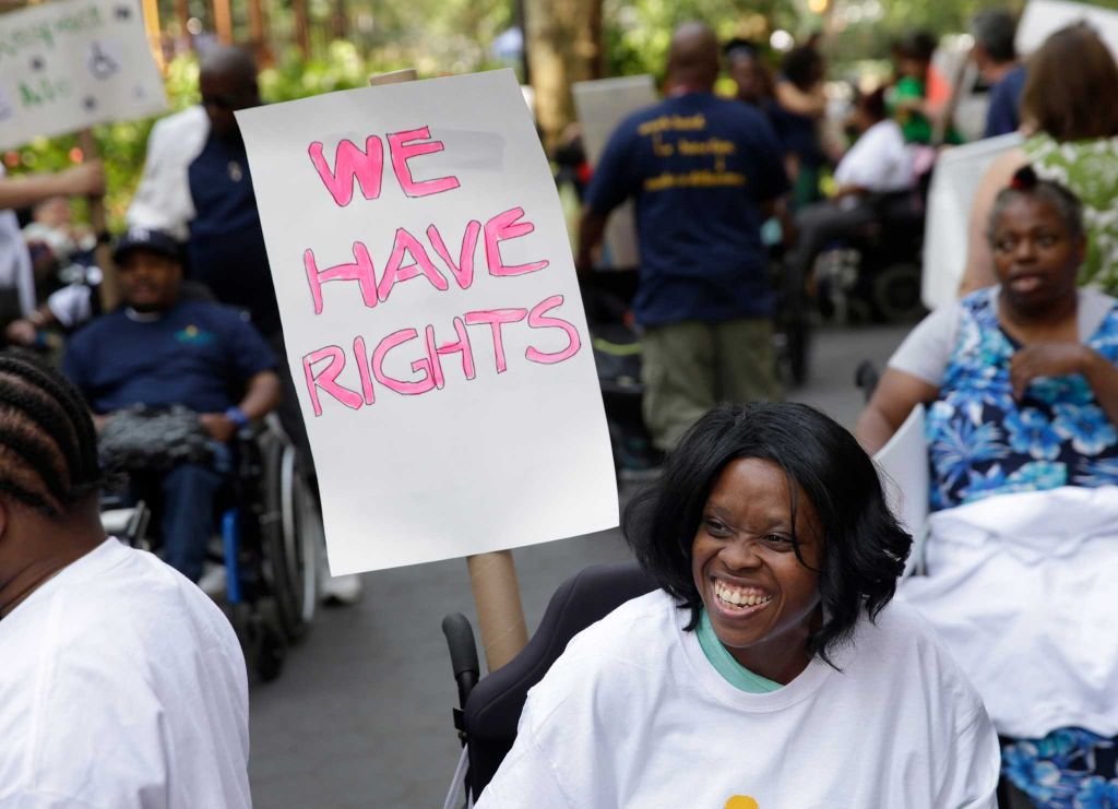 A group of people holding a sign saying "We have rights"