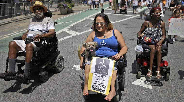 Jessica Delarosa, and her dog Mayim, and two other wheelchair marchers participate in the inaugural Disability Pride Parade
