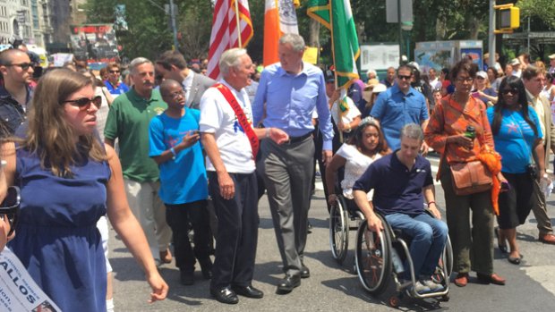 Mayor Bill de Blasio and former U.S. Sen. Tom Harkin march in the first Disability Pride Parade in Manhattan on July 12, 2015. 