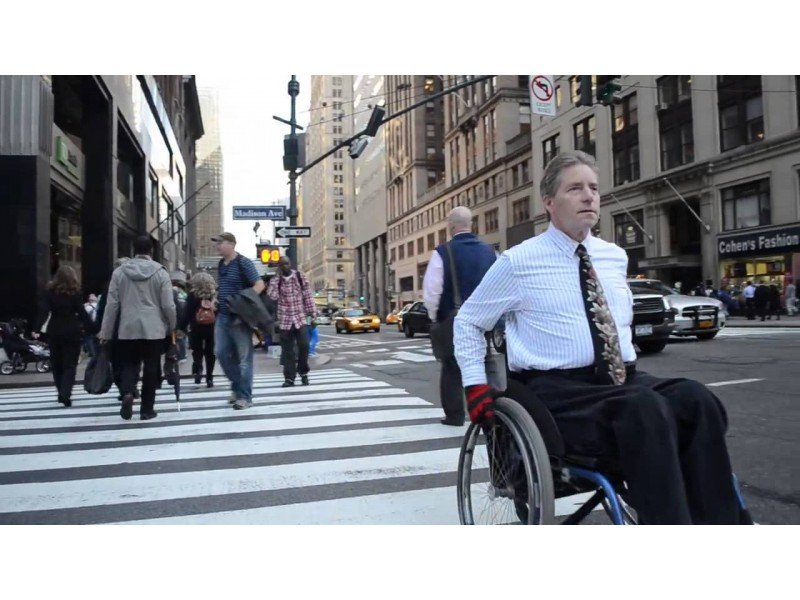 Man in wheelchair in downtown Manhattan Man in wheelchair in downtown Manhattan