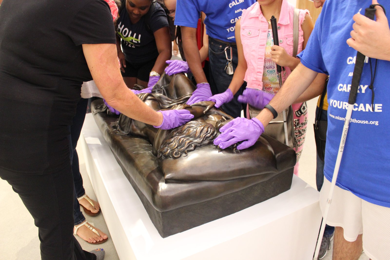 Hands on touch tour of a reclining bronze sculpture