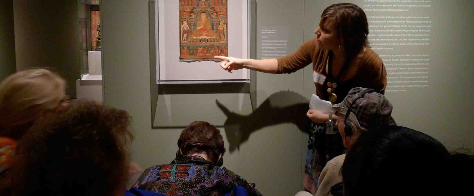 Group of people looking at a piece of art