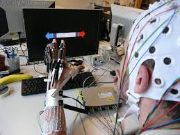Person wearing wired glove & helmet with for brain-computer interaction Photo ec.europa.eu