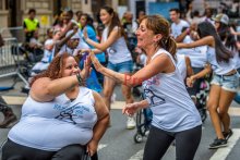 Two dancers highfiving each other at parade