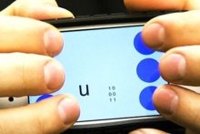 Hands on smart phone using braille Photo from Georgia Tech