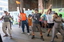 A group of people dancing with their hands in the air