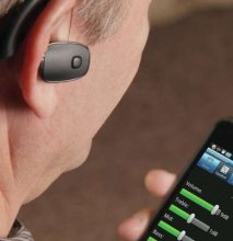Man with hearing aid and personal amplifier Photo Trendhunter.com