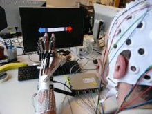 Person wearing wired glove & helmet with for brain-computer interaction Photo ec.europa.eu