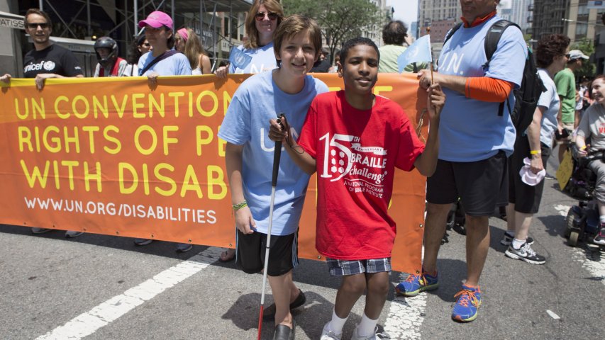 Disabled Teenager marching through the parade