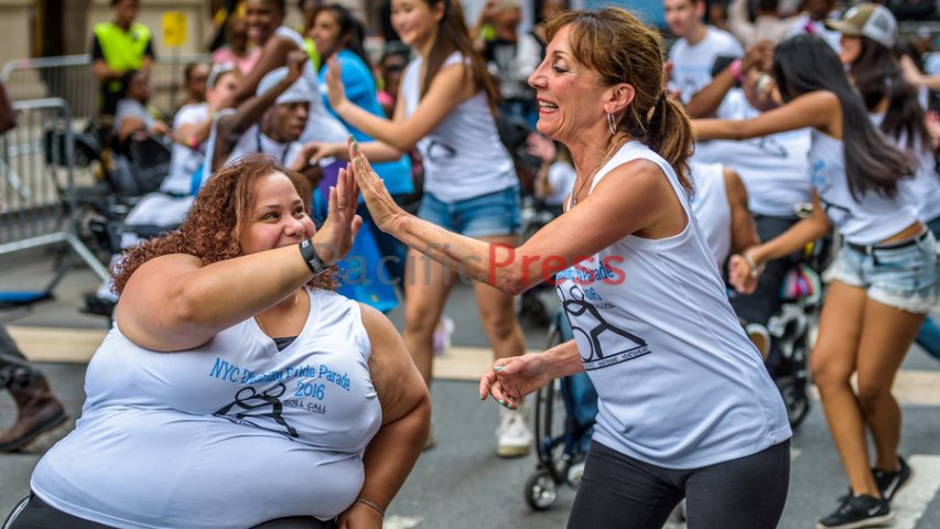 Two dancers highfiving each other at parade