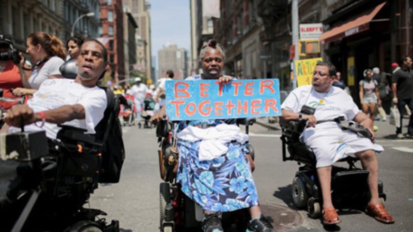 People on wheelchairs with different disabilities take part in the disability pride parade in New York