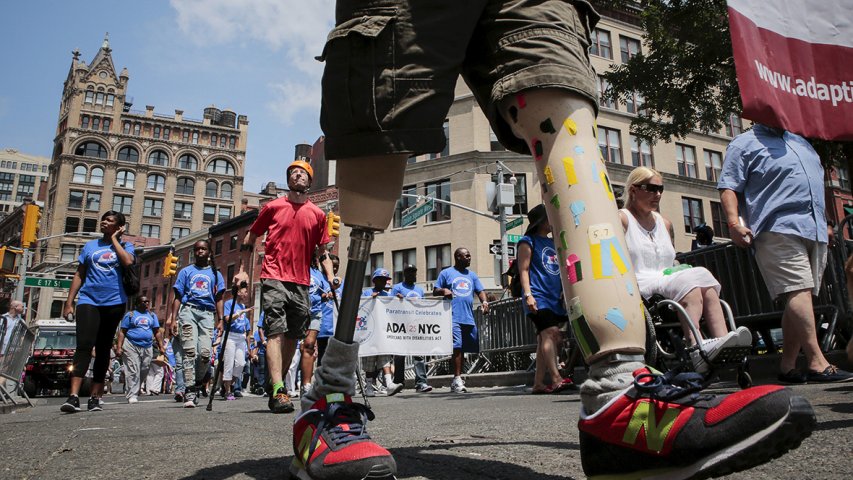 Donald Lee, a bilateral amputee, marches in the Disability Pride parade