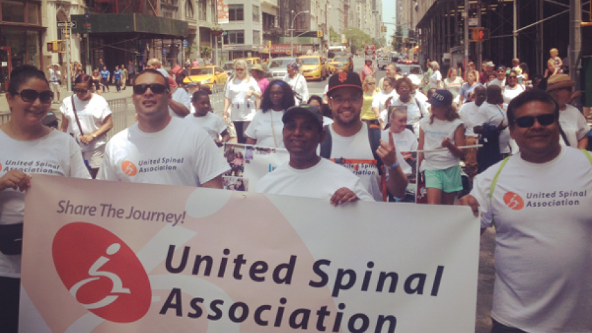 United Spinal Association group marching down the street